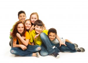 Group of diversity looking kids, boys and girls sitting on the floor, in white background