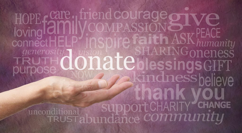Hand holding word "Donate", cancer donations to Hearth Place