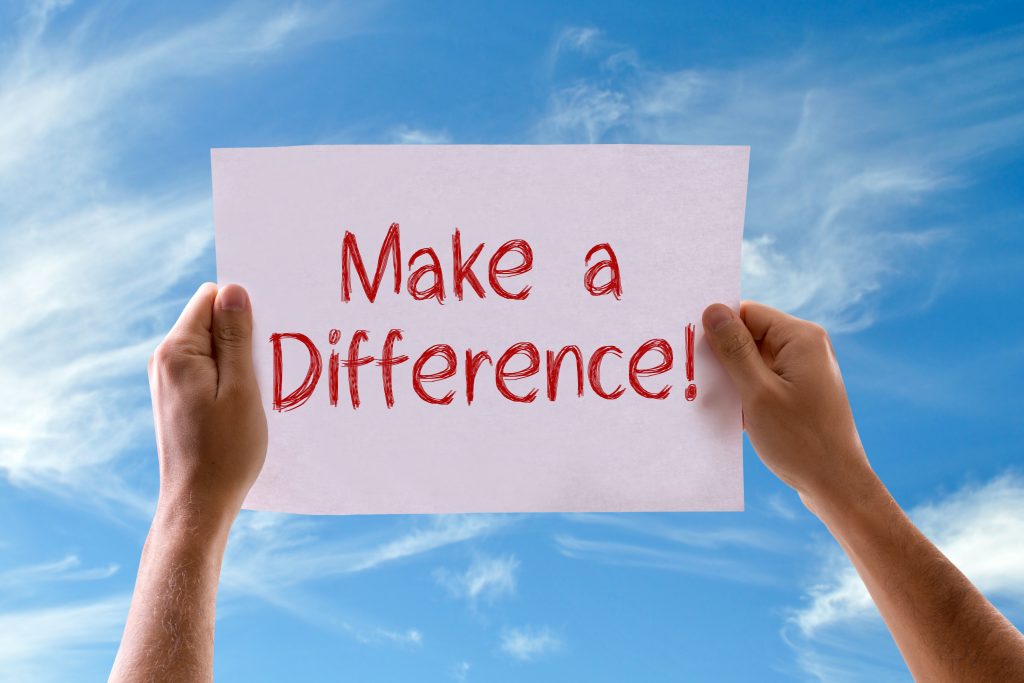 hands holding a sign "Make a Difference"