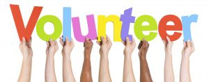 Diverse Hands Holding The Word Volunteer